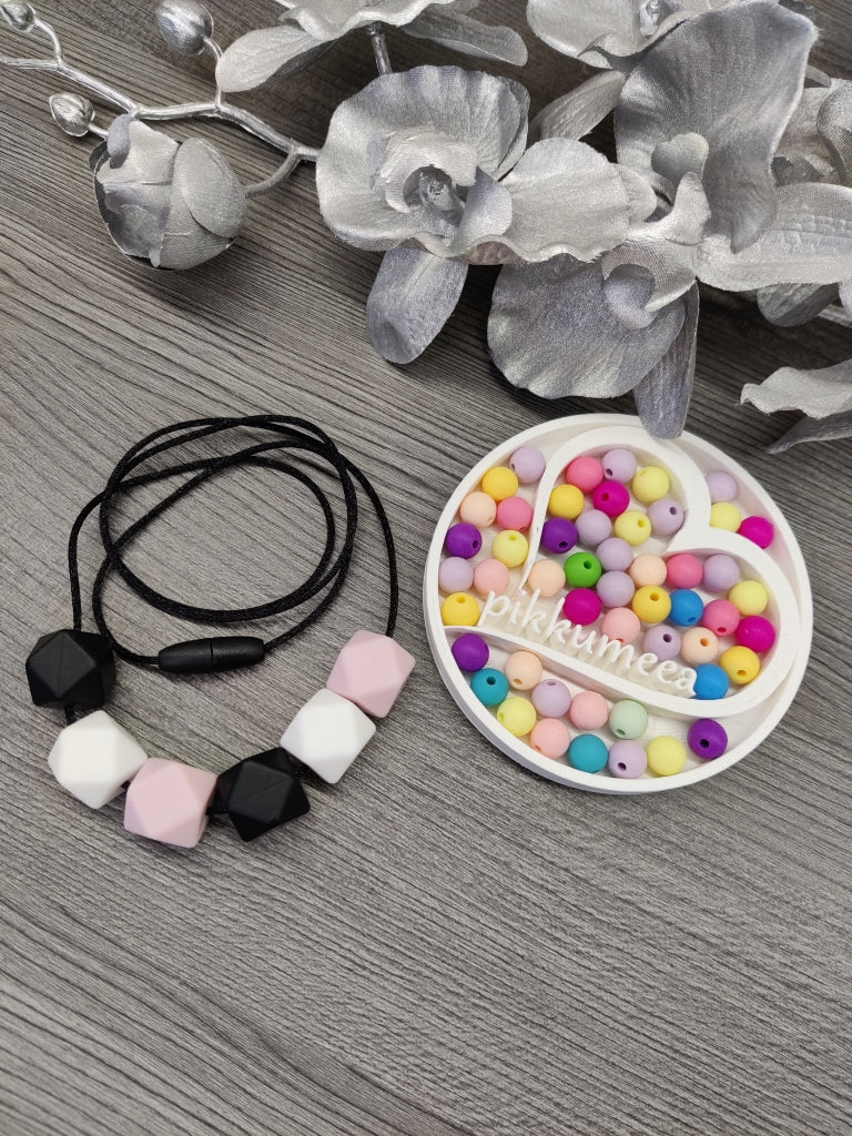 Imetys-/kantokoru (musta / vaaleanpunainen / valkoinen)